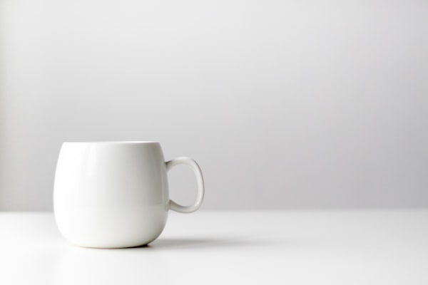 Ceramic modern coffee mug handled carefully by barista